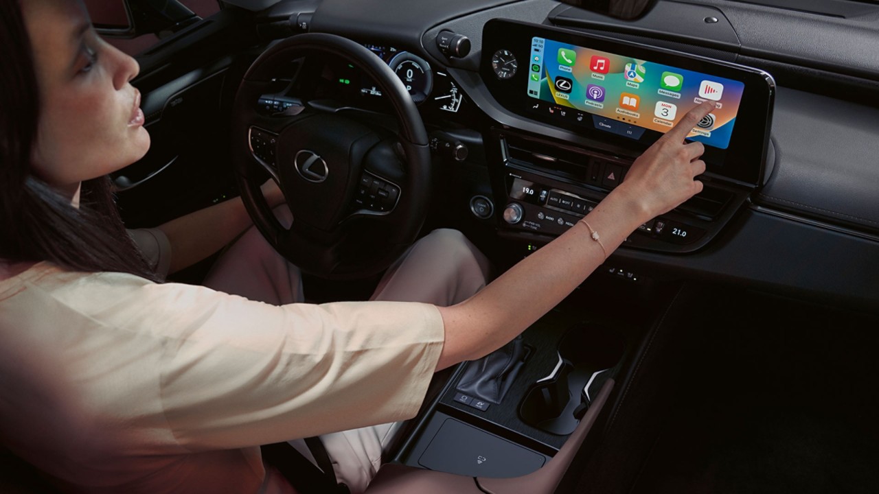 A person interacting with a Lexus touchscreen display