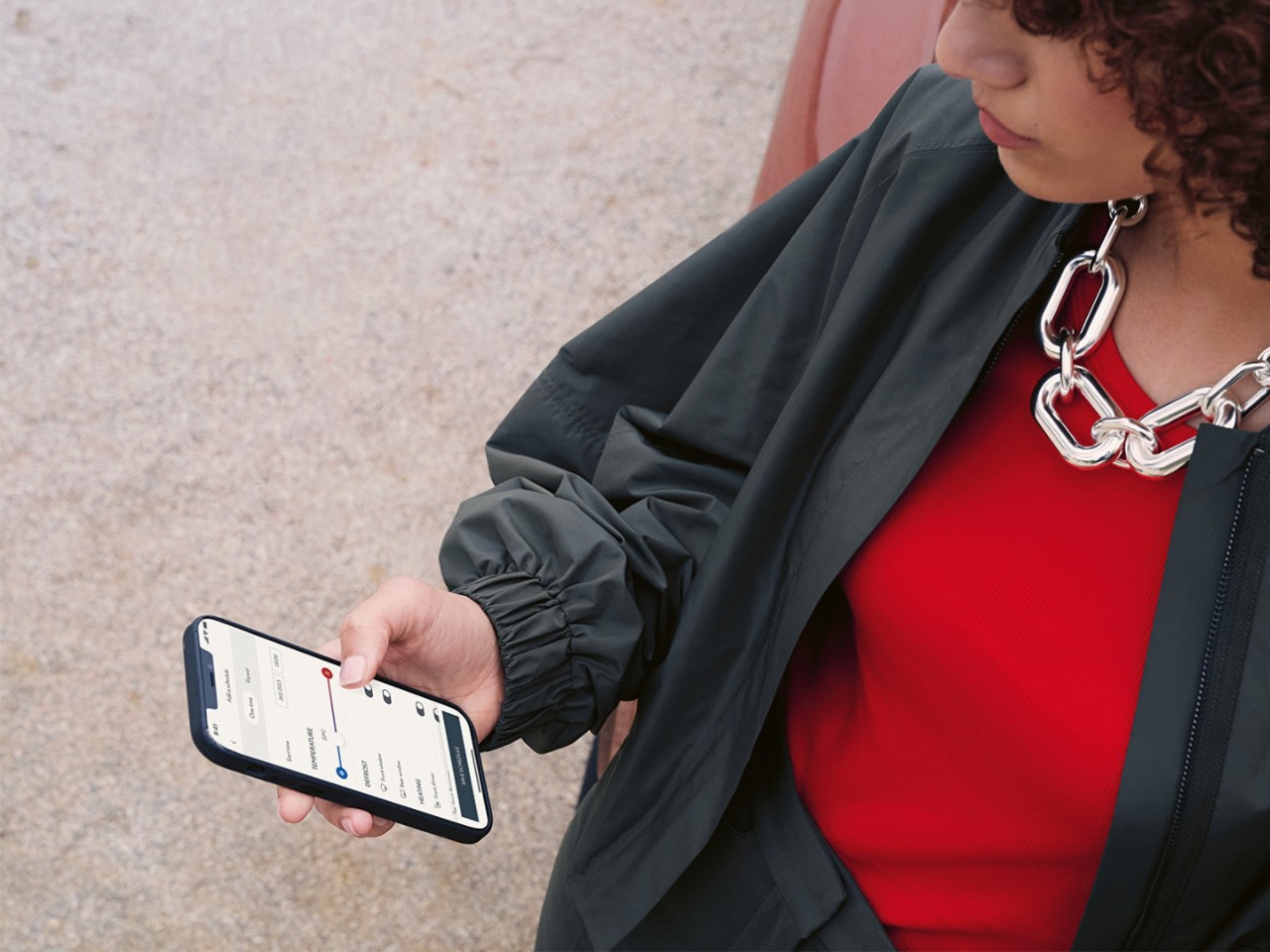 A person using a mobile phone to access the Lexus Link+ app