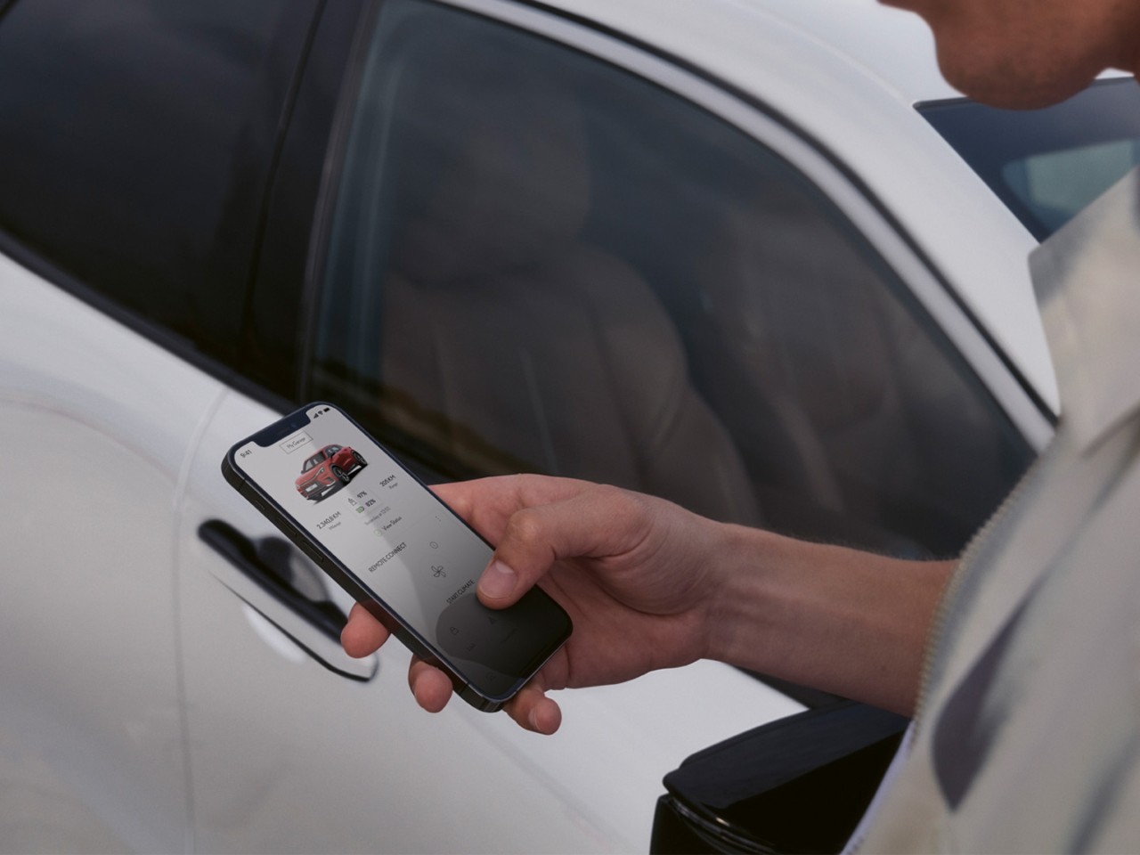 A person using a mobile phone to access the Lexus Link+ app