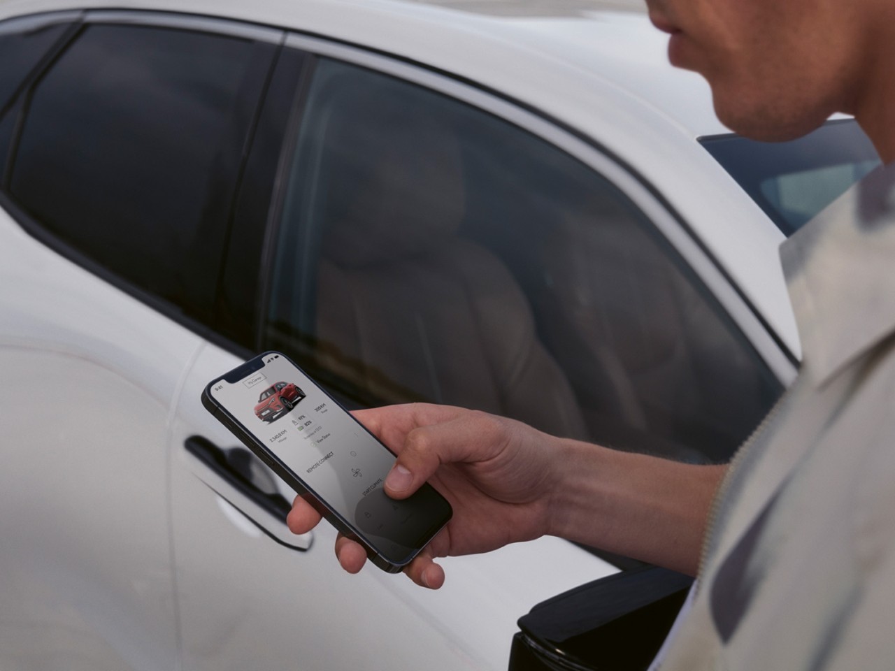 A person using a mobile phone to access the Lexus Link app